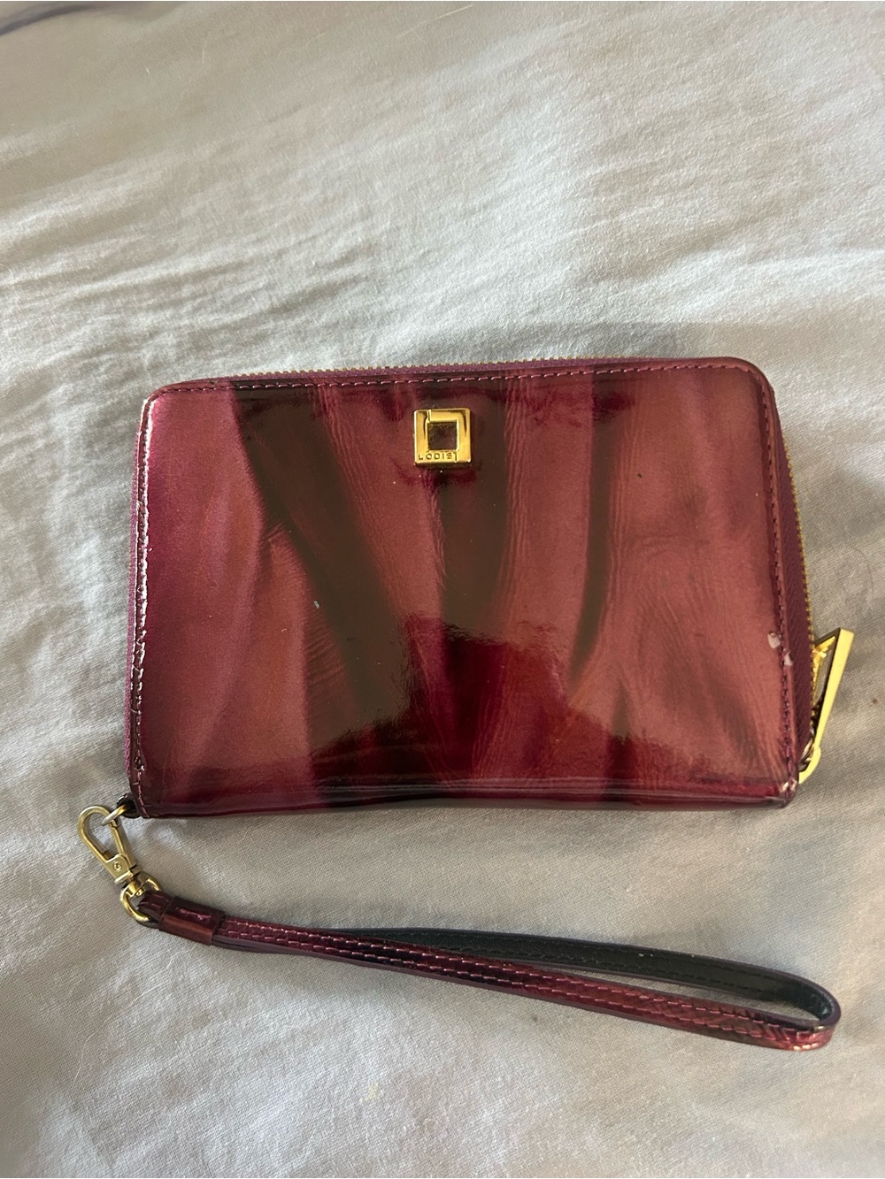 Hard to find patterned Patent Purple Wristlet Wallet with Gold Tone Hardware.